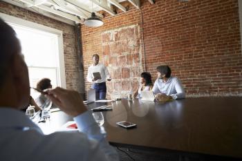 Group Of Businesspeople Meeting In Modern Boardroom