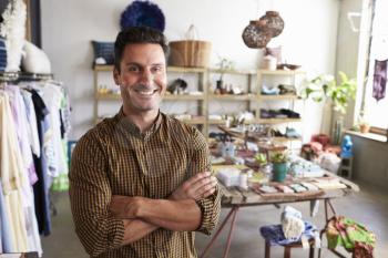 Young male business owner in a clothes shop, portrait