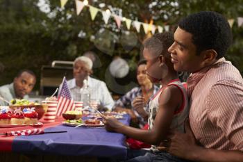 Black father and son at family 4th July barbecue, close up