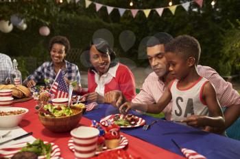 Multi generation black family members at a 4th July barbecue