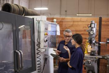 Engineer Training Female Apprentice On CNC Machine