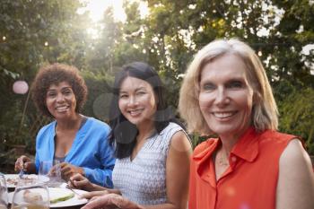 Portrait Of Mature Female Friends Enjoying Outdoor Meal