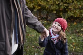 Grandfather And Granddaughter Enjoying Autumn Walk