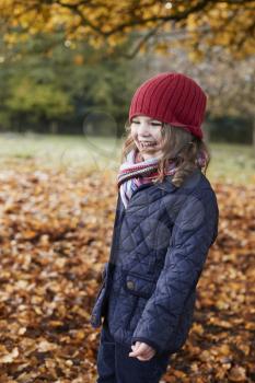 Young Girl Playing With Leaves On Autumn Walk