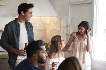 Friends spending time together hanging out in the kitchen