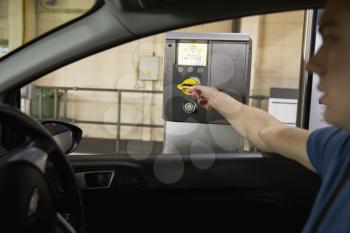 Driver Collects Ticket From Machine In Car Park