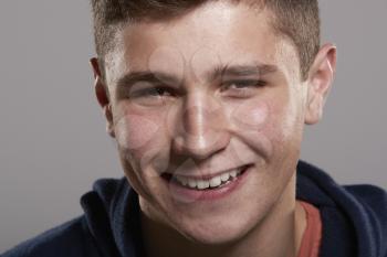 Teenage boy smiling to camera, close up