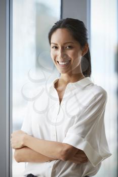 Portrait Of Businesswoman Standing By Window In Office