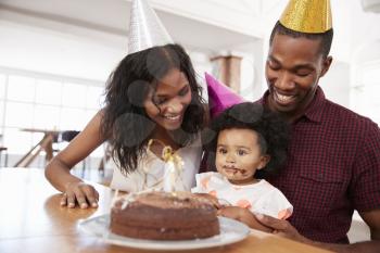 Parents Celebrating Birthday With Young Daughter At Home