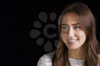 Head And Shoulders Studio Portrait Of Smiling Young Woman