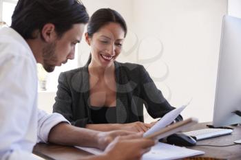 Man and woman looking at documents in an office, close up