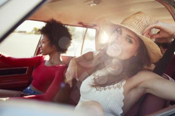 Portrait Of Friends Relaxing In Car During Road Trip