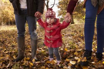 Close Up Of Young Girl On Autumn Walk With Parents