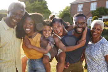 Multi generation black family, parents piggybacking kids