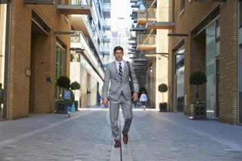 Businessman Walking to Work Along City Street