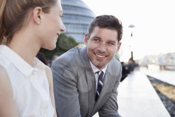 Businesspeople Walking To Work By River Thames In London