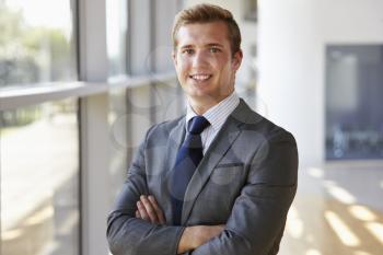 Portrait of a young smiling professional man, arms crossed