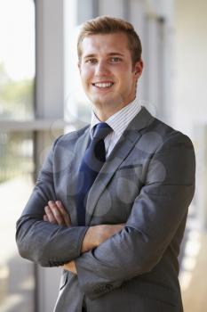 Portrait of a young smiling professional man, arms crossed