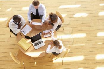 Four business colleagues in a team meeting, aerial view