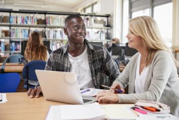 College Student Has Individual Tuition From Teacher In Library