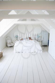 Couple Sleeping In Light And Airy White Bedroom