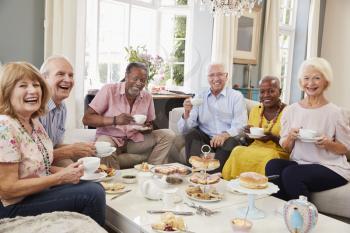 Portrait Of Senior Friends Enjoying Afternoon Tea At Home