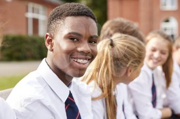 Portrait Of Teenage Students In Uniform Outside School Buildings