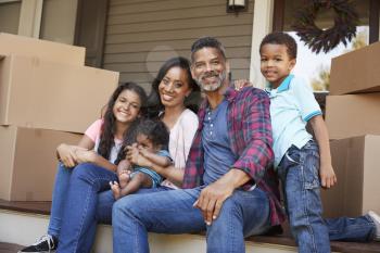 Family With Children Outside House On Moving Day