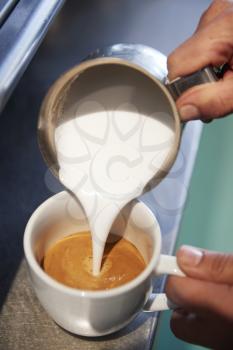 Close Up Of Male Barista Using Coffee Machine In Cafe