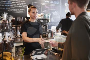 Customer Paying In Coffee Shop Using Credit Card