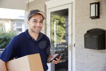 Portrait Of Courier With Digital Tablet Delivering Package