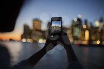 Silhouette Of Tourist Taking Photo Of Manhattan Skyline At Dusk