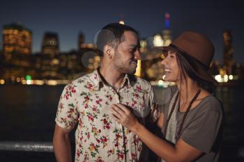 Romantic Couple With Manhattan Skyline In Background At Dusk