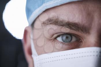 Male healthcare worker in scrubs head shot, close up crop