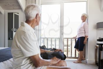 Senior Couple Arriving At Summer Vacation Rental