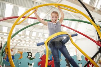 Young white girl having fun using a human gyroscope