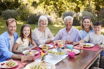 Three generation family having lunch in the garden