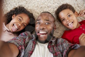 Point Of View Shot Of Father And Children Posing For Selfie