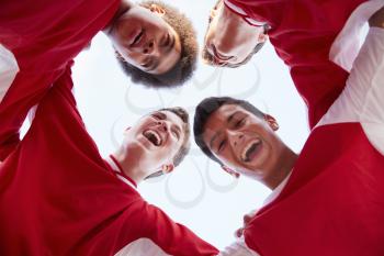 Low Angle View Of Male High School Soccer Players Having Team Talk