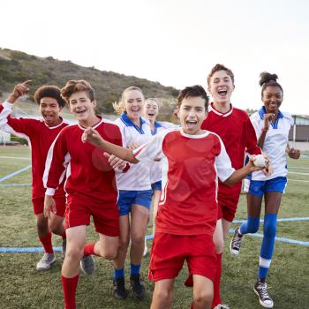 Portrait Of Male And Female High School Soccer Teams Celebrating