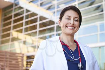 Smiling Hispanic female healthcare worker outdoors, portrait