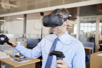 Businessman using VR technology in an office, close up