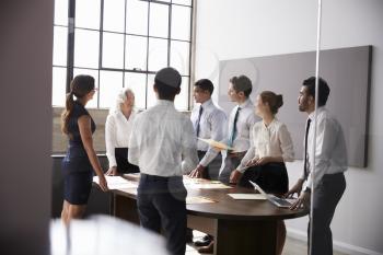 Female manager and business team standing in a  meeting room