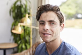 Young male business owner at a coffee shop, portrait