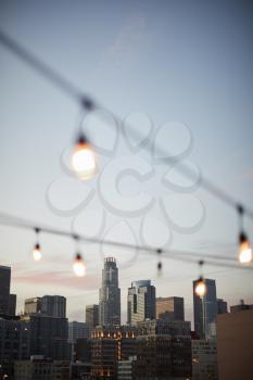 View Of Los Angeles Skyline At Sunset  With String Of Lights In Foreground