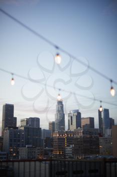 View Of Los Angeles Skyline At Sunset  With String Of Lights In Foreground