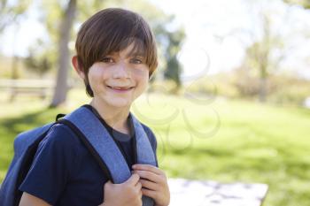 Young schoolboy looks to camera and smiles, portrait