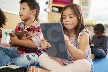 Elementary school class using tablet computers, close up