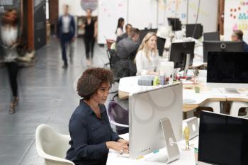 Business Team Working At Desks In Modern Open Plan Office