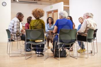 People Attending Self Help Therapy Group Meeting In Community Center